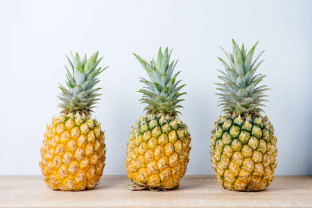 Ripe pineapples on a wooden table background.の写真素材