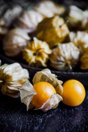Closeup orange organic cape gooseberries on wooden backgroundの写真素材