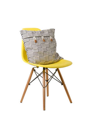 Backrest pillow on yellow color chair isolated on white background.の写真素材