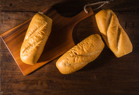 Freshly baked French baguette on table background.