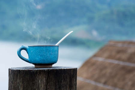 Hot Coffee cup on the wooden and Homestay camping  at Doi Luang Chiang Dao background.の写真素材