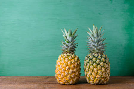 Ripe pineapples on a wooden table background.の写真素材