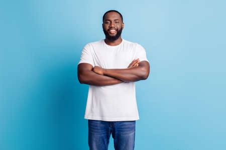 African worker manager standing with arms crossed nice smile on blue backgroundの写真素材