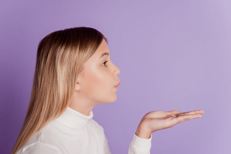 Profile photo of carefree lady send air kiss look copyspace wear white jumper posing on purple...