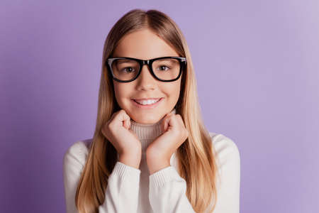 Photo of positive small girl hold hands cheeks toothy beaming smile wear glasses look cameraの写真素材