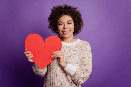 Photo of woman hold red paper heart big shape card shiny smileの写真素材
