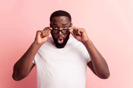 Portrait of shocked crazy man amazed look take off glassesの写真素材