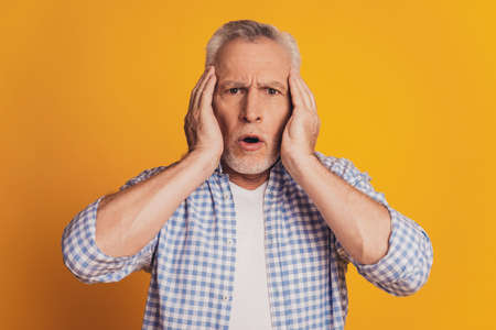 Portrait of a senior man suffering from headacheの写真素材