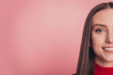 Close up photo of amazing girl good mood hiding half face standing over pink backgroundの写真素材