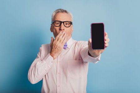 Photo of gentleman showing smart phone new model.