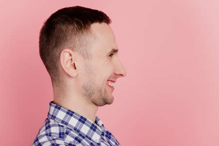 Profile side photo of young handsome man confident smart look empty space isolated over pink color backgroundの写真素材