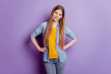Close up photo of charming pretty girl hands hips look camera on violet backgroundの写真素材