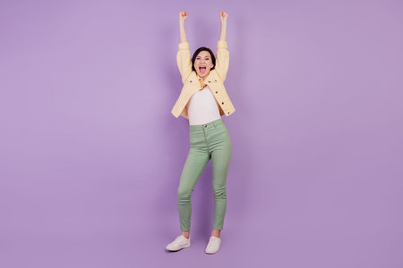 Portrait of astonished crazy girl cheerful reaction open mouth raise hands on purple background