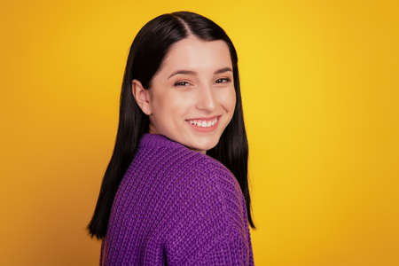 Profile side photo of attractive young woman happy positive toothy smile cute lovely isolated over yellow backgroundの写真素材