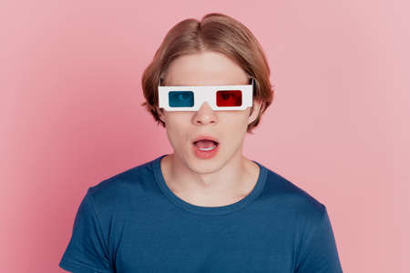 Photo of young excited man wear 3d glasses watch film amazed surprised isolated over pastel color backgroundの写真素材
