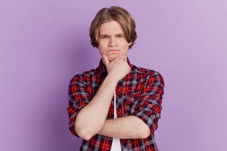 Portrait of minded intelligent guy fingers chin look camera on purple backgroundの写真素材