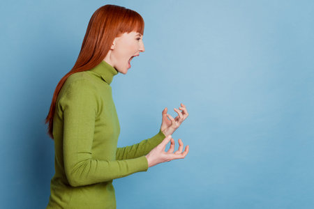 Profile side photo of mad woman scream empty space isolated over blue background