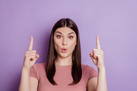 Portrait of young girl promoter point index finger up amazed surprised advertise promo choice...