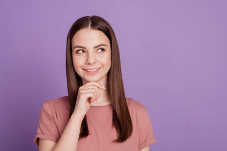 Portrait of girl look copyspace think touch chin hands isolated over violet backgroundの写真素材