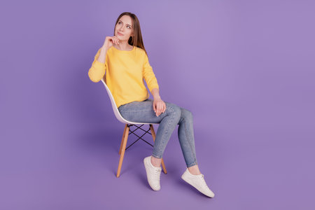 Portrait of inspired clever creative lady sit armchair rest dream think thoughts on purple backgroundの写真素材