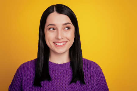 Portrait of young beautiful cute cheerful girl smiling looking at camera over yellow background.の写真素材