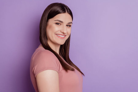 Profile side photo of nice pretty attractive girl happy positive smile cheerful isolated over violet color backgroundの写真素材