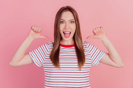 Portrait of confident egocentric lady indicate thumbs herself open mouth on pink background