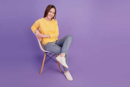 Portrait of dreamy relaxed cute lovely lady sit armchair cheerful smile on purple backgroundの写真素材