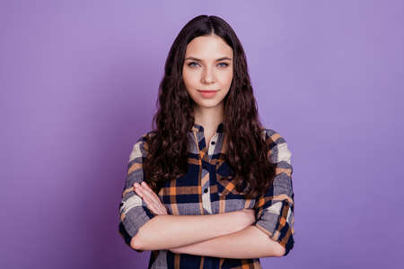 Portrait of nice good attractive girl holding arms crossed looking at camera confident isolated on violet backgroundの写真素材
