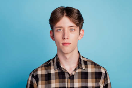 Photo of serious young charming attractive man wear casual outfit isolated on blue color backgroundの写真素材