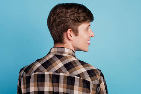 Profile side photo of young cheerful guy good mood look empty space barber shop isolated over blue color backgroundの写真素材