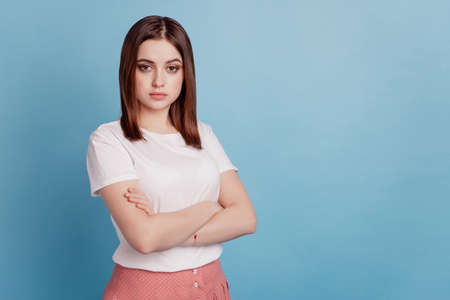 Profile side photo of young attractive confident lady folded hands smart peaceful isolated over teal color backgroundの写真素材