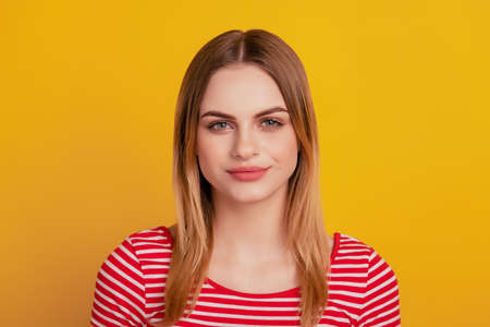 Photo of young attractive woman good mood confident casual outfit isolated over yellow color backgroundの写真素材