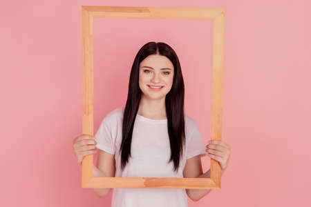 Photo of funny portrait concept lady hold wooden frame isolated on pink color backgroundの写真素材
