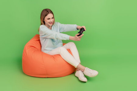 Full body profile side photo of young girl play video game gamepad competition weekend isolated...