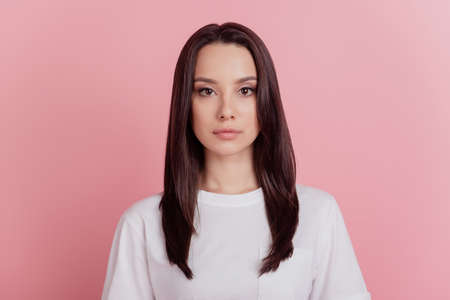 Photo of young attractive confident business woman calm agent manager isolated over pink color backgroundの写真素材