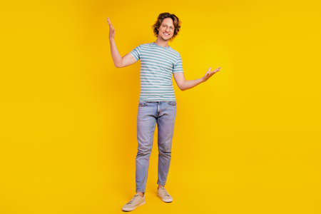 Full length body size photo of young handsome man have fun cool hipster isolated on yellow color backgroundの写真素材