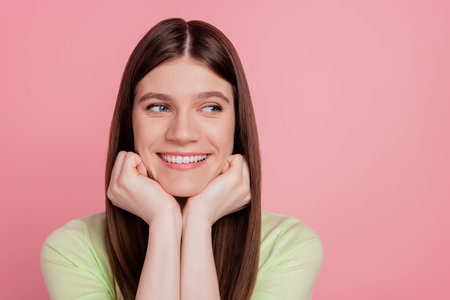 Portrait of nice girl happy positive smile dream look empty space isolated over pink color...