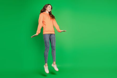 Portrait of dreamy lady jump sporty have fun on green background