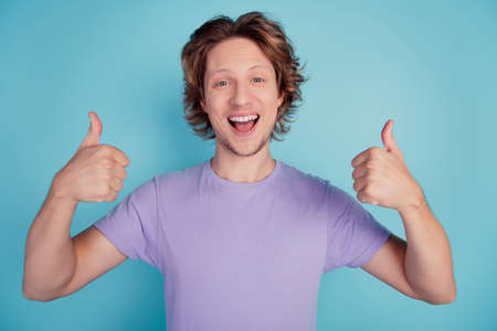 Photo of excited man happy positive smile show thumb-up fine great perfect isolated teal color backgroundの写真素材