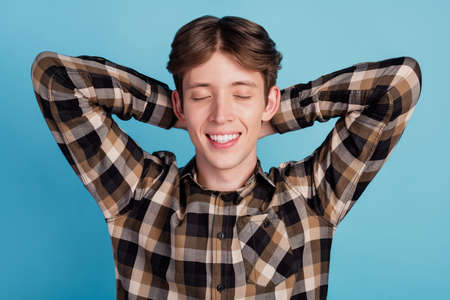 Top above high angle view photo of young guy sleep drowse relax hands behind head isolated blue color backgroundの写真素材