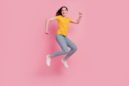 Photo of cheerful relaxed brunette woman jump run go shopping wear casual jeans clothes on pink...