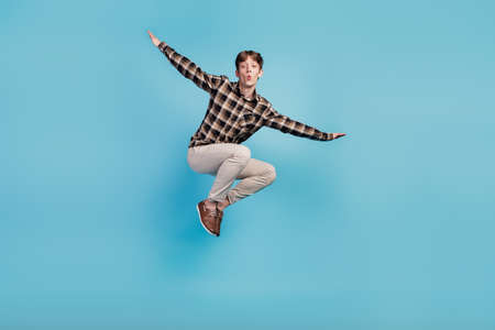 Full size photo of young guy have fun jump up fly air wings wear casual outfit isolated on violet color backgroundの写真素材