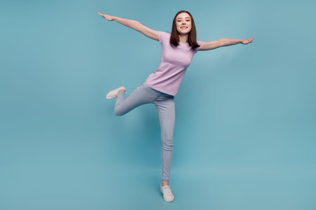 Full body photo of cheerful girl good mood hands wings fly plane casual outfit isolated over teal...