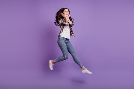 Full length photo of young attractive girl happy positive smile jump up fly air casual outfit...