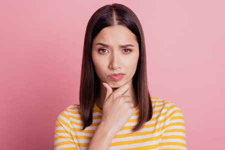 Photo of intelligent uncertain serious lady finger chin look camera on pink background