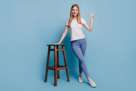 Portrait of cheerful reliable funky blonde lady direct finger empty space wear white t-shirt...