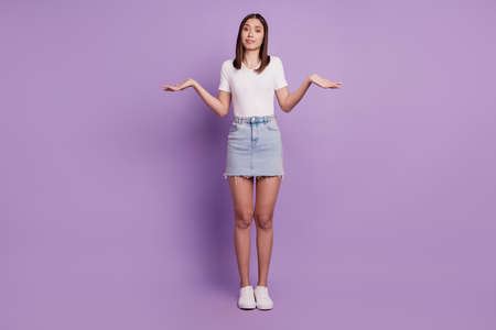 Photo of clueless uncertain unsure lady shrug shoulders look camera on purple backgroundの写真素材