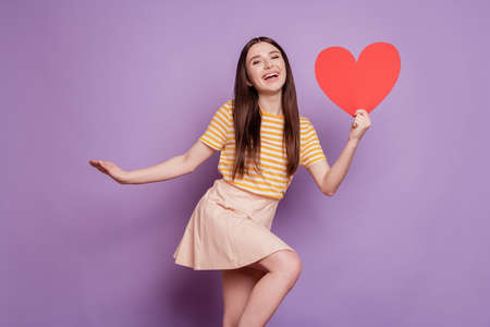 Portrait of dreamy pretty stunning cute lady hold heart shape postcard posing on violet backgroundの写真素材