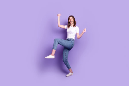 Full size photo of young excited lady good mood rejoice victory fists hands isolated over purple...